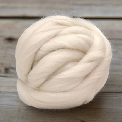 Natural white skein of light white felt on a table.